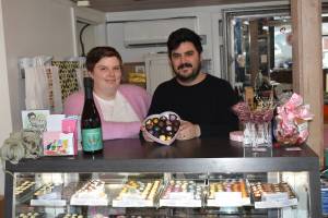 Kelley Balcomb-Bartok Staff photo
Kathryn and Roberto Moya celebrate Valentines Day and their new community with a box of chocolates and other fine local goodies at their store.
