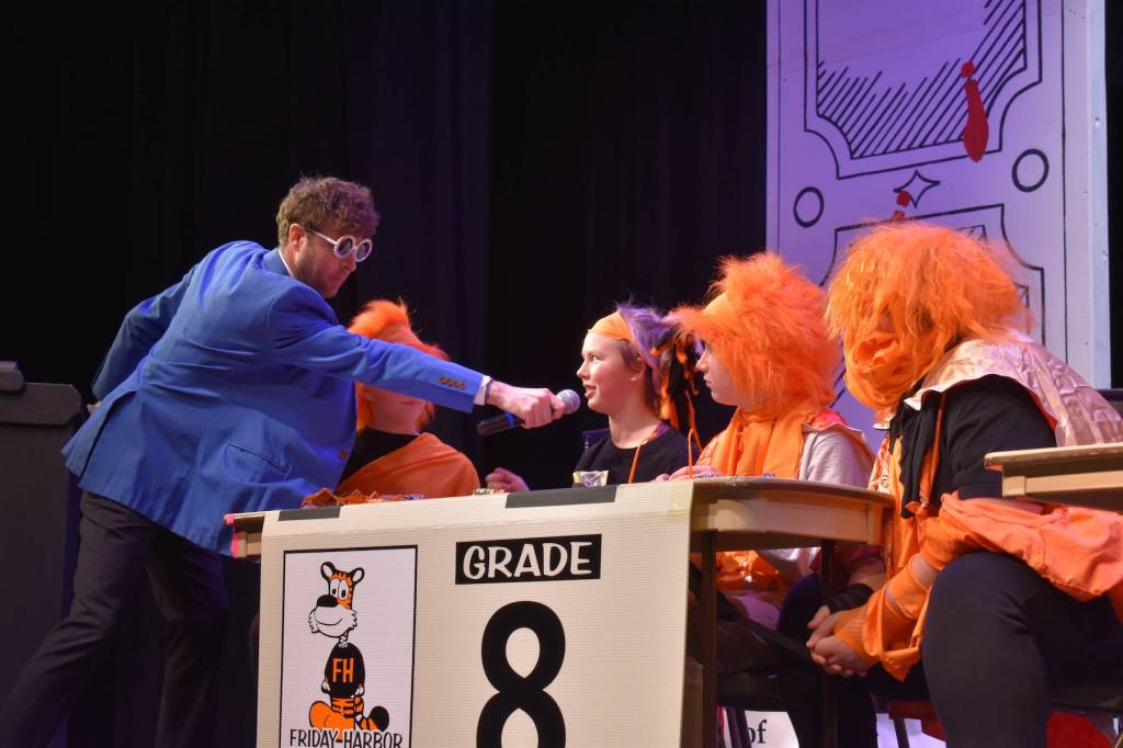 Kelley Balcomb-Bartok \ Staff photo
MC Mason Turnage holds the microphone for Liv Eisenhardt, a member of the Friday Harbor Middle School eighth grade team during the San Juan Public Schools Foundations 28th annual Knowledge Bowl.