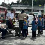 Heather Spaulding \ Staff photo
Young Cub Scouts were given flowers to toss into the harbor.