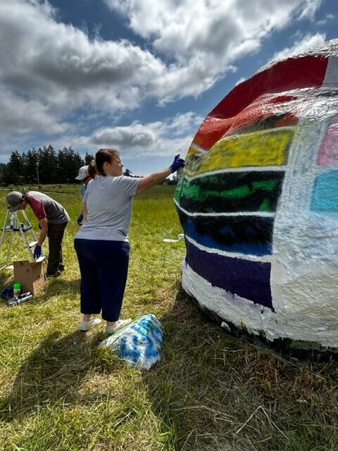 Heather Spaulding  Staff photo
Community members working to fix the vandalized Pride flag.
