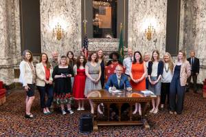 Contributed photo
Gov. Jay Inslee signs new protections into law.