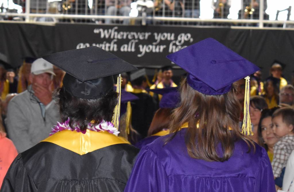 Kelley Balcomb-Bartok / Staff photo Cody
Balcomb-Bartok and Shelby Mullin proceed down the center aisle towards the stage of the 111th Commencement of the Friday Harbor High School, with a saying credited to Confucius over their heads: Wherever You Go, Go With All Your Heart