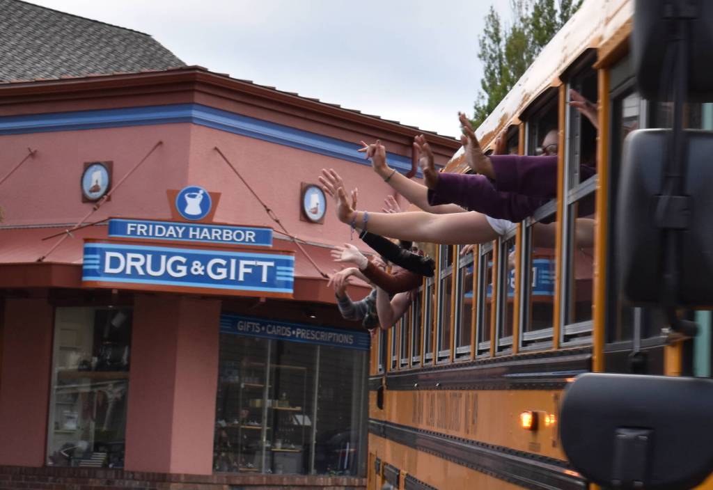 Kelley Balcomb-Bartok / Staff photo
Friday Harbor graduates wave from the school bus as they parade through the streets of Friday Harbor.