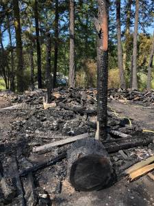 Kelley Balcomb-Bartok \ Staff photo
Charred remains of the woodshed.