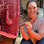 Contributed photo
Olivia Hawkins next to the tunas first dorsal fin. When the fin is raised it acts as a sail, allowing the fish to make sharp turns while pursuing prey. Dissection revealed the muscle and tendons that help retract the fin for streamlined swimming.