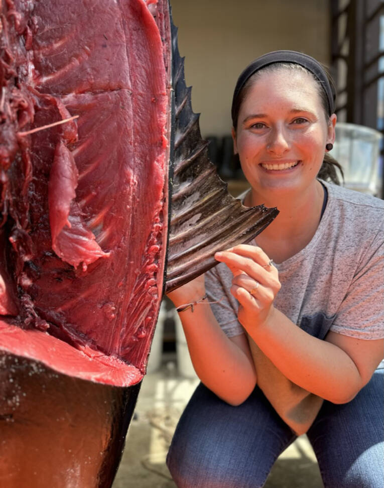 Contributed photo
Olivia Hawkins next to the tunas first dorsal fin. When the fin is raised it acts as a sail, allowing the fish to make sharp turns while pursuing prey. Dissection revealed the muscle and tendons that help retract the fin for streamlined swimming.