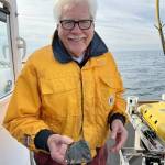 Adam Summers photo
Dr. H. Gary Greene holds a sample of vesicular basalt at the site of the Devils Mountain Volcano
