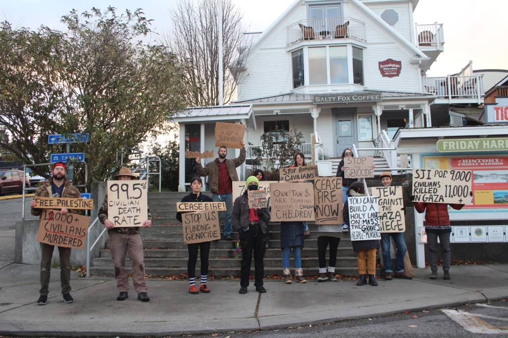 Heather Spaulding / Staff photo
Those calling for a cease-fire Nov. 15 made their way down to the ferry to catch the attention of those disembarking the boat.