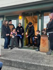 Contributed photo
Nate Fihn cuts the ribbon held by his two childen. Chamber Director Becki Day, President Roberto Moya and board member Deborah Hoskins cheer them on.