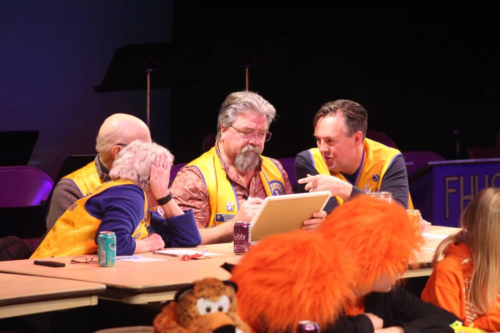 Staff photo/ Isabel Ashley
The Lions discuss their answer to the final question, earning the runner-up title behind the 9th and 10th grade team.