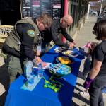 Isabel Ashley \ Staff photo
Sheriff Eric Peter hands out bracelets as another officer adds stamps to a childs passport to get an Easter treat.
Isabel Ashley \ Staff photo
Sheriff Eric Peter hands out bracelets as another officer adds stamps to a childs passport to get an Easter treat.