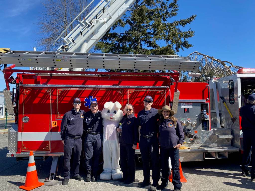 Isabel Ashley \ Staff photo
SJI First Responders pose with the Easter bunny in front of a firetruck parked at Wells Fargo Bank for the annual SJI Firefighters Association Easter Walk on March 31.
Isabel Ashley \ Staff photo
SJI First Responders pose with the Easter bunny in front of a firetruck parked at Wells Fargo Bank for the annual SJI Firefighters Association Easter Walk on March 31.
