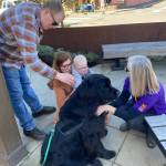 Isabel Ashley \ Staff photo
A family gives attention to Koda, who is training to be a working dog to provide stress relief and comfort to those who have just experienced a disaster such as a fire.
Isabel Ashley \ Staff photo
A family gives attention to Koda, who is training to be a working dog to provide stress relief and comfort to those who have just experienced a disaster such as a fire.