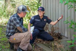 Photo credit: Washington Department of Natural Resources
San Juan Island EMS and Fire and Rescue volunteer Kathleen Salinas conducting an at-home fire risk assessment with Adam Green as part of the launch of Wildfire Ready Neighbors, an initiative to help prepare communities to protect their homes from wildfires.