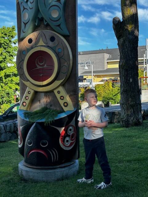 Heather Spaulding / Staff photo
Lisa Lawrences grandson places cedar bows on one of the Portals of Welcome