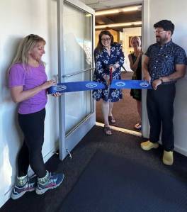 Heather Spaulding \ Staff phot
o Anna Maria de freitas, Chamber Board member and Roberto Moya, Chamber President, hold the ribbon as April Randall cuts it.