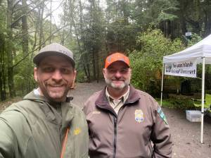 <em>WDFW district biologist Kurt Licence and BLM staff at the kiosk near Watmough Bay on southern Lopez Island. </em>