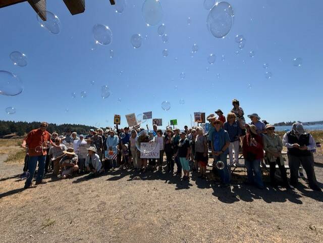 Heather Spaulding \ Staff photo
Islanders after making a heart in the sand at Jacksons Beach July 17.