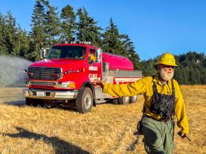 Ben Luna photo.
Orcas firefighter Bob Nutt works to make a wildland fire area safe.
