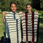 Coast Salish Wool Weaving Center.
Two girls share the garments theyve woven.