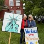 Liza Michaelson and Lovell Pratt holding their signs.
