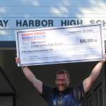 Heather Spaulding photo.
Sam Garson holds the check over his head.