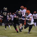 John Stimpson photo.
Wolverine #13 Duncan Bogart closes in to stop the running back.