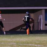 John Simpson photo.
Wolverine #8 Channing Kleine runs the sideline for a touchdown.