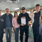 Contributed photo.
Capt. John McMillian (center) with Sheridan Ferguson and her father (left center), Brent Campbell and family (right), and Margaret Pommert with U.S. Sailing Foundation (far left).