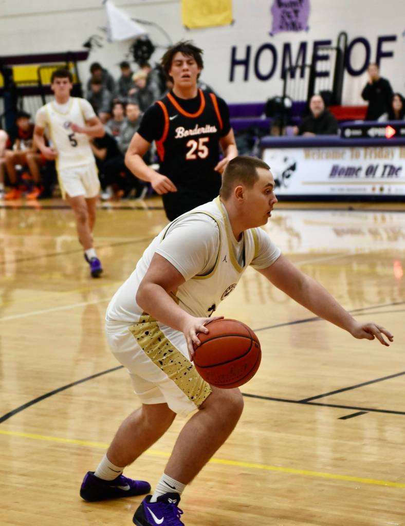 John Stimpson photo.
#33 David Markham drives toward the basket.