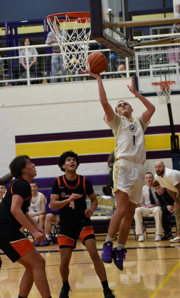 John Stimson photo.
#1 Duncan Bogart shoots for two points.