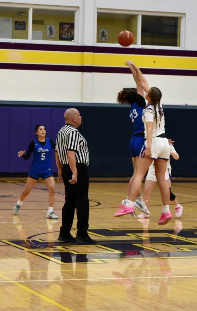 John Stimpson photo.
Vera Schoultz, #10, controls the opening tipoff.
