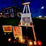 Contributed photo by
Ronda Bishop Candles and signs in tribute to Alex Pretti