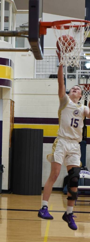Contributed photo by John Stimpson 
Ben Baisch, #15, stretches for a two point layup.