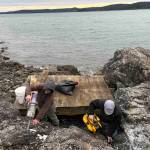 Contributed photo.
Community members use battery vacuums to clear the debris.