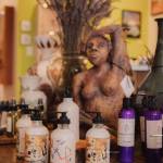 Paintings from local artists adorn glass bottles of lavender lotion, surrounded by sculpture and lavender.
